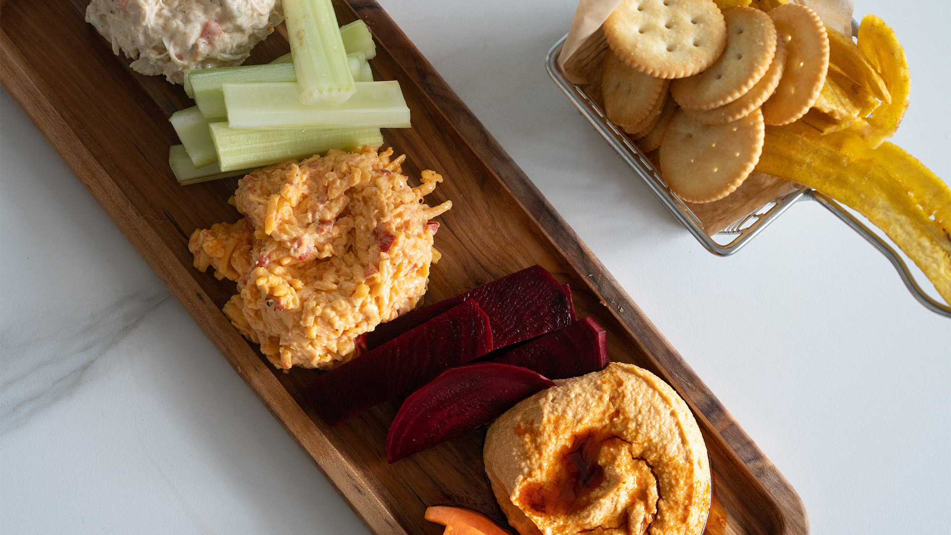 a wooden plate with different foods on it