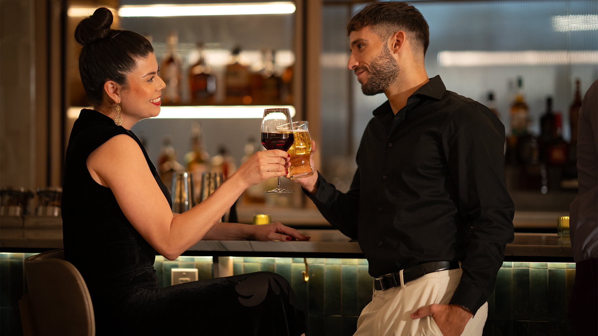 a man and woman holding glasses of wine