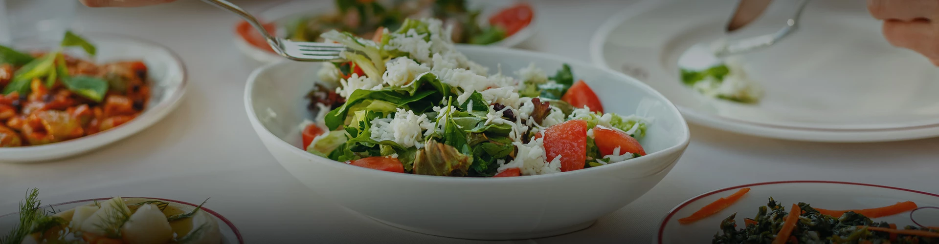a bowl of salad with cheese and tomatoes