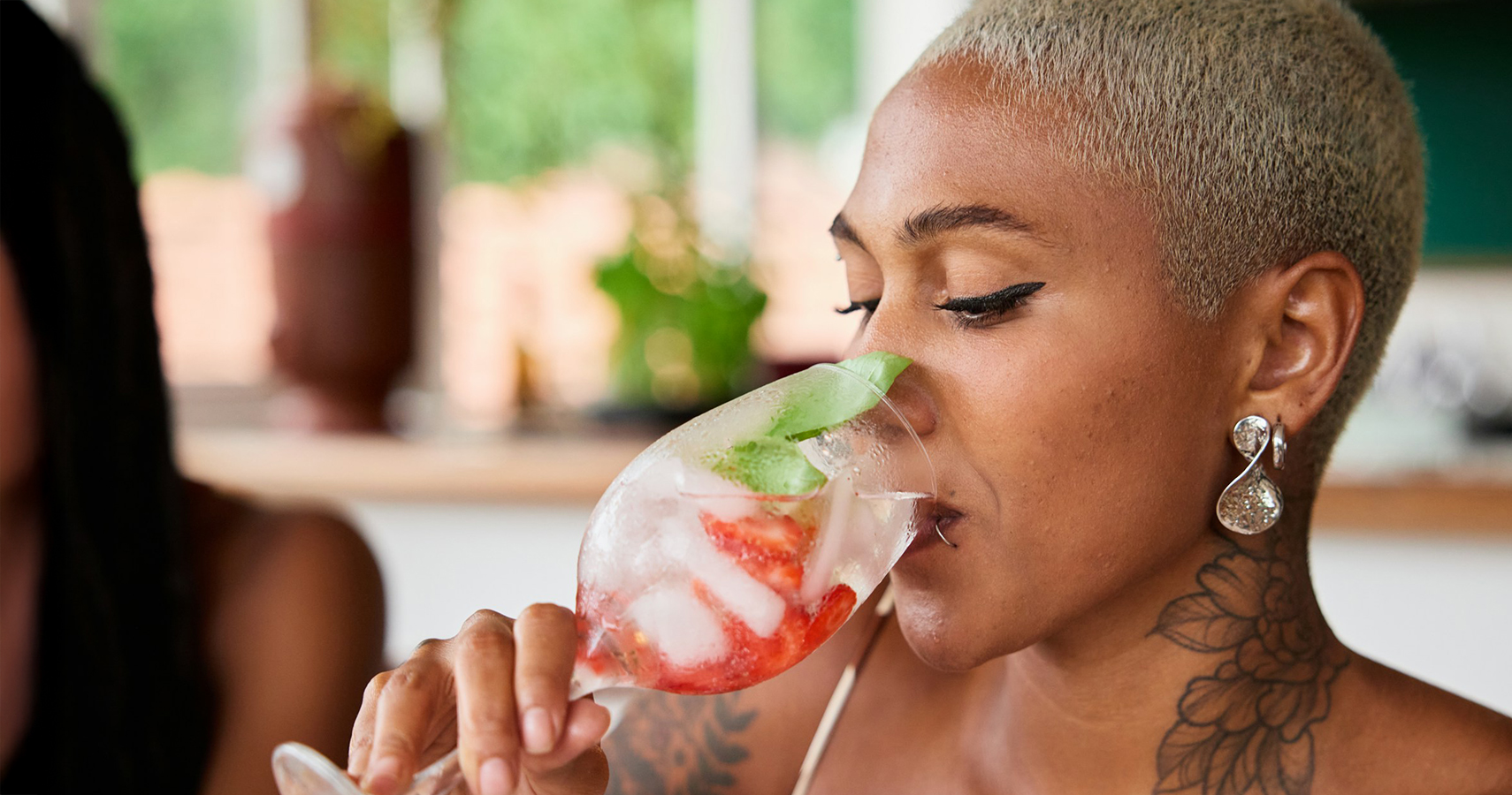 a woman drinking from a glass