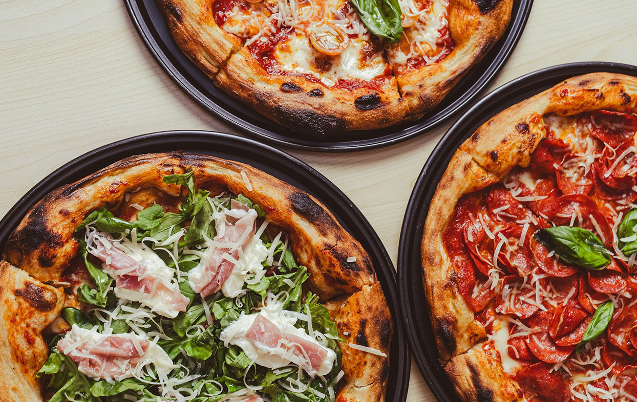 a group of pizzas on a table