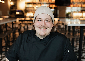 a man wearing a beanie and smiling