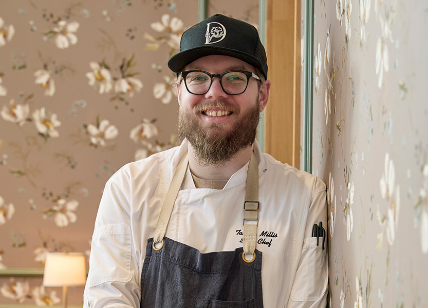 a man wearing a hat and apron