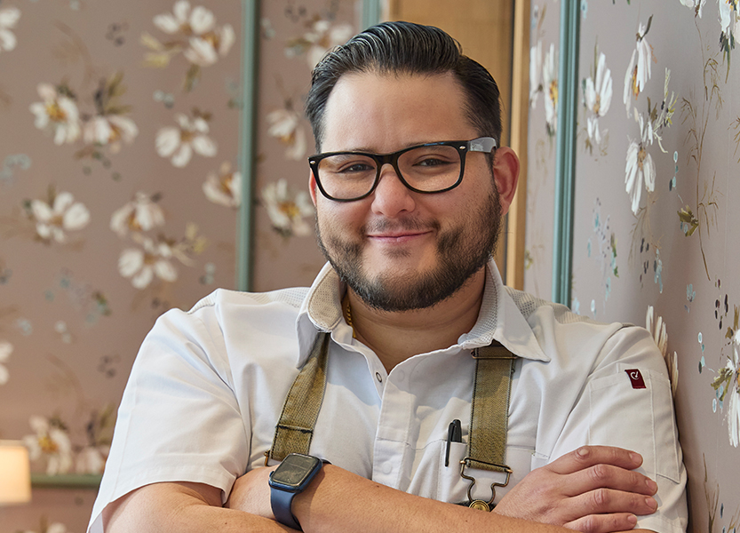 a man with glasses and a beard wearing suspenders