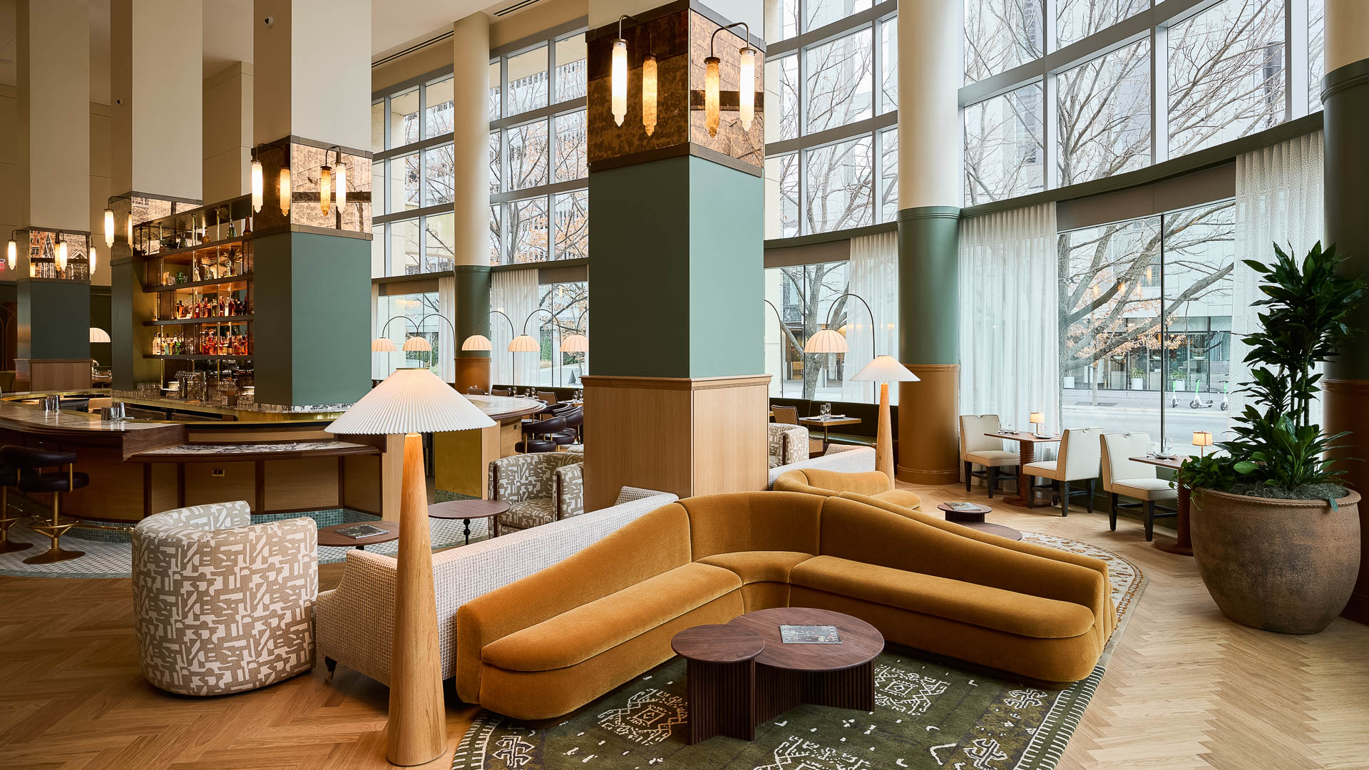 a room with a large column and couches