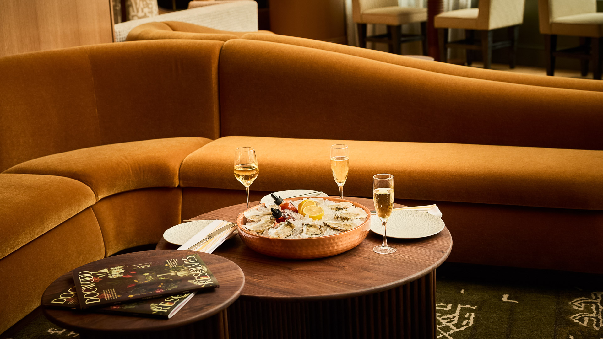 a bowl of food on a table with glasses of champagne