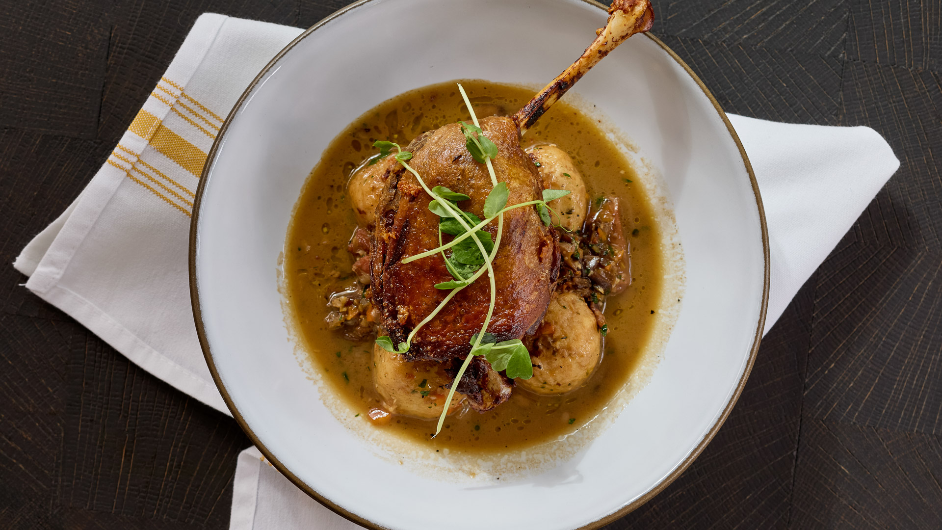 a bowl of food with a piece of meat on it