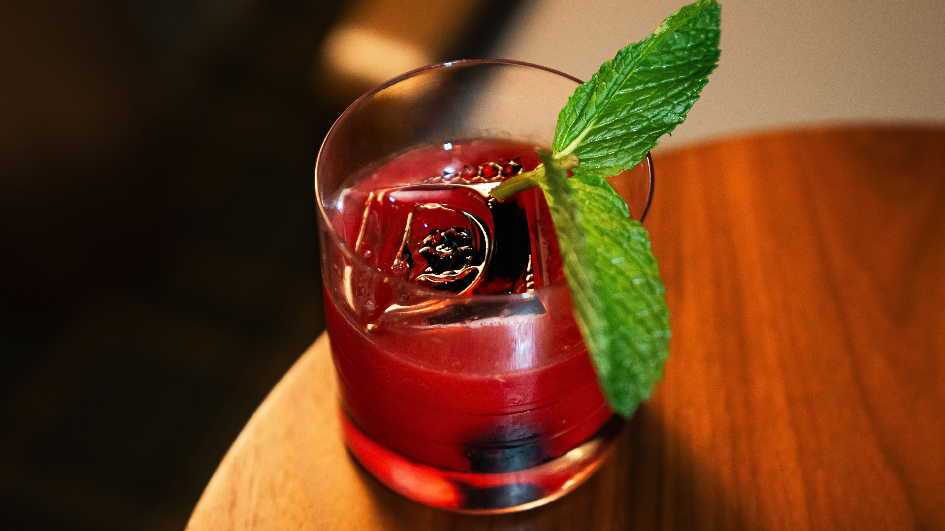 a glass with a drink and a leaf on top