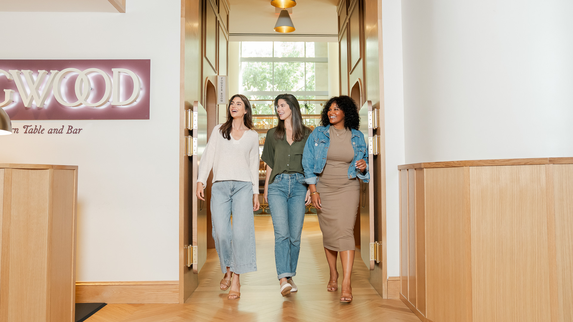 a group of women walking in a hallway
