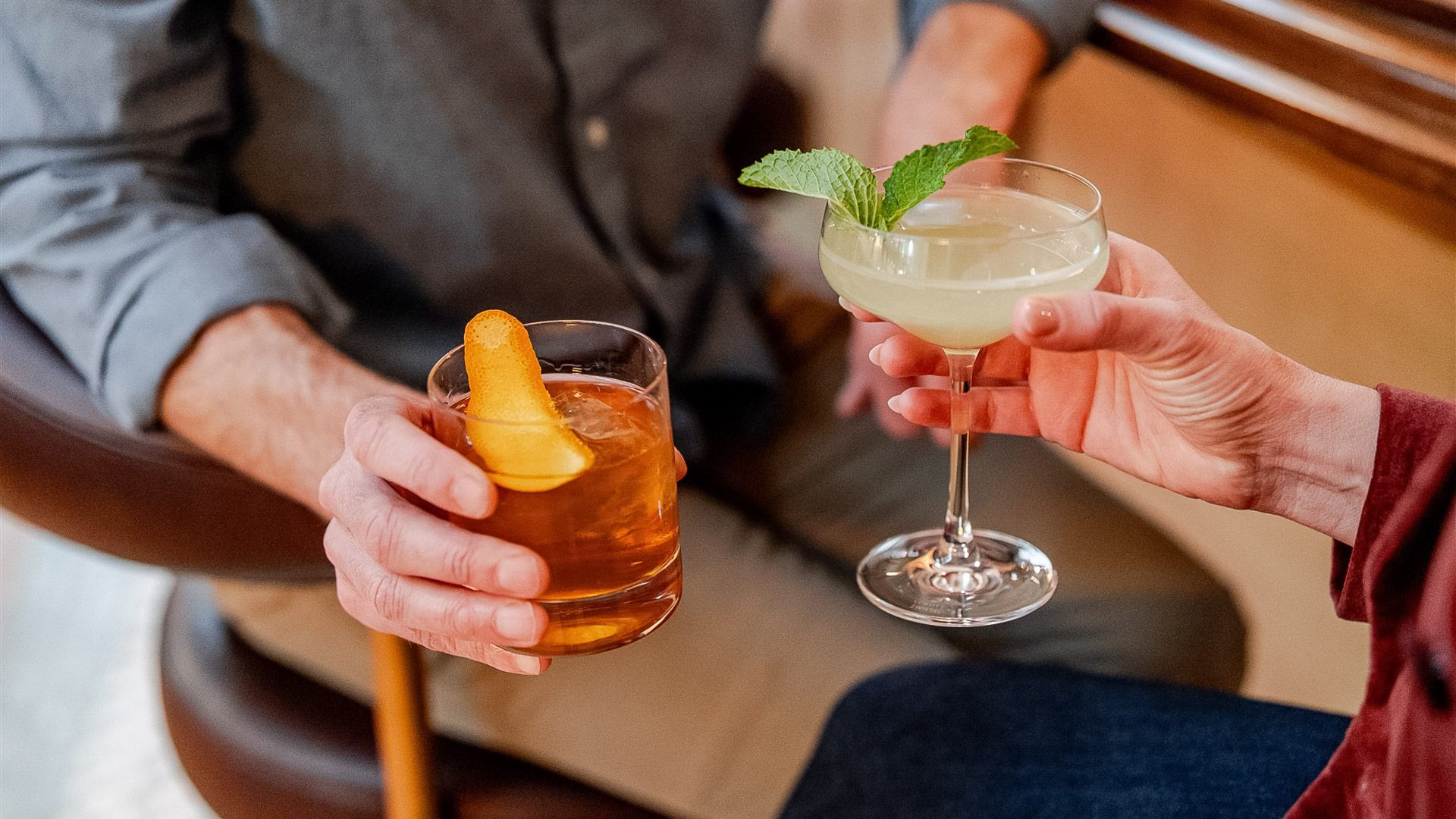 a pair of hands holding drinks