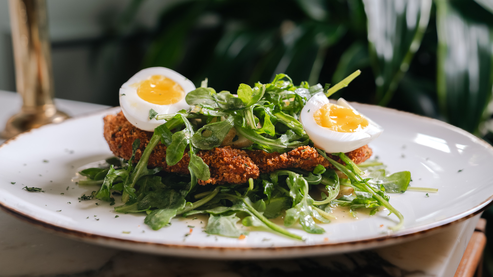 a plate of food with eggs and greens