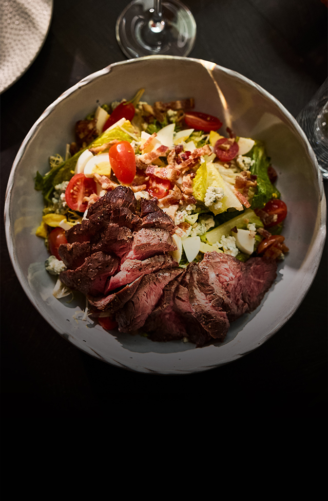 a bowl of salad with meat and vegetables