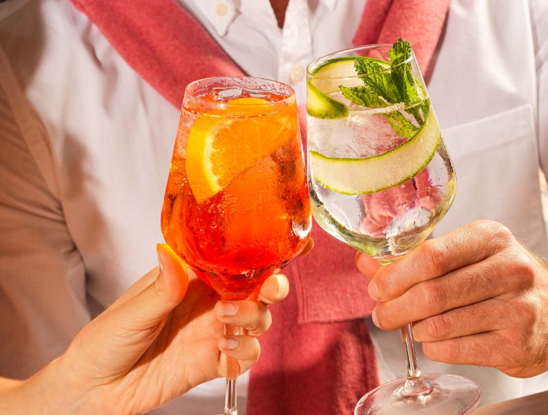 a person holding up a glass of liquid
