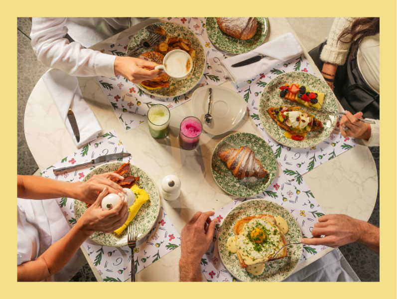 a group of people eating breakfast at a table