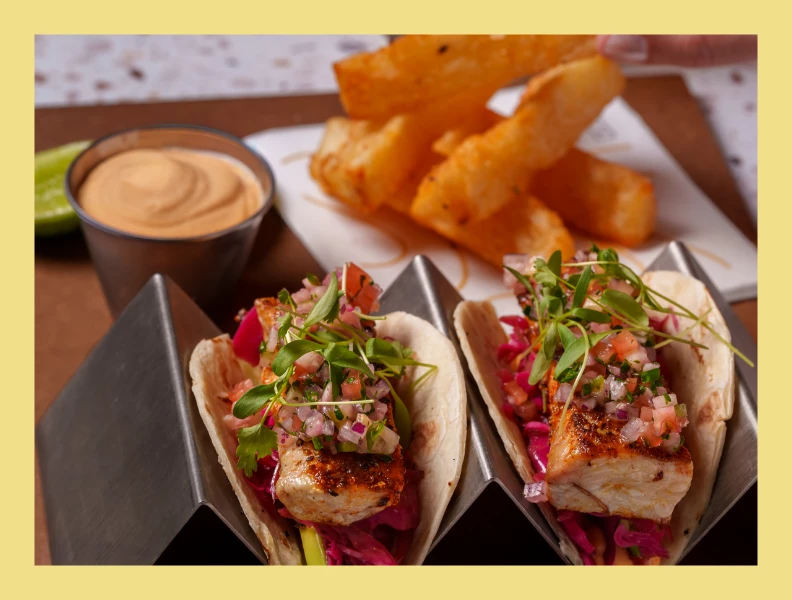 a tacos with sauce and fries