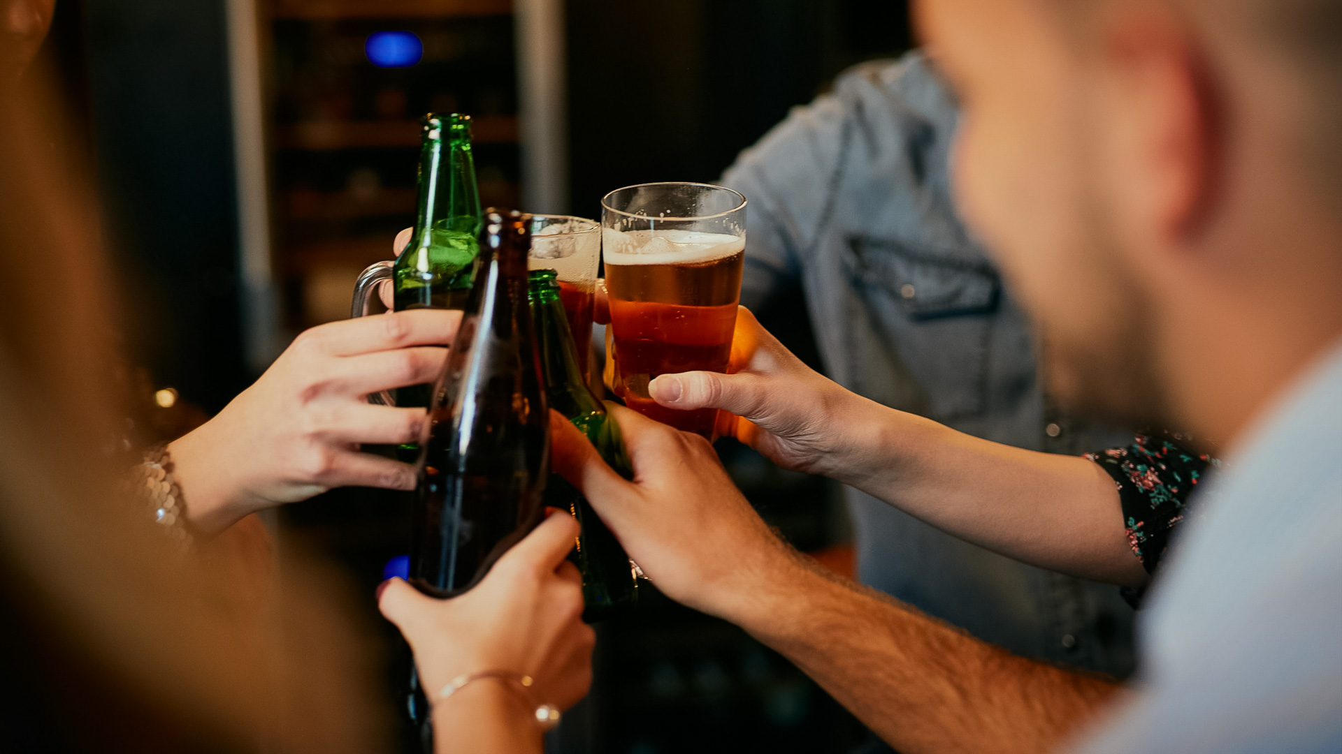 a group of people holding up beer glasses