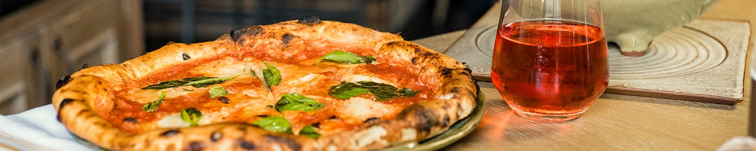 a pizza with basil on a plate