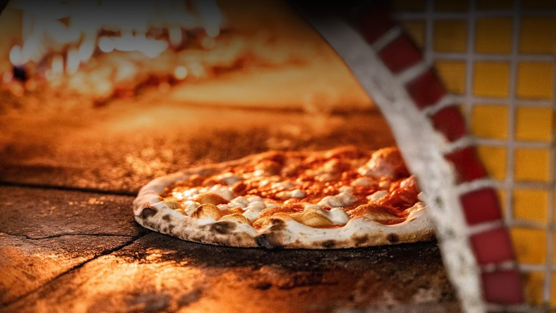 a pizza being cooked in a wood oven