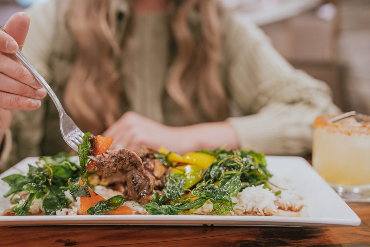 a person eating food on a plate