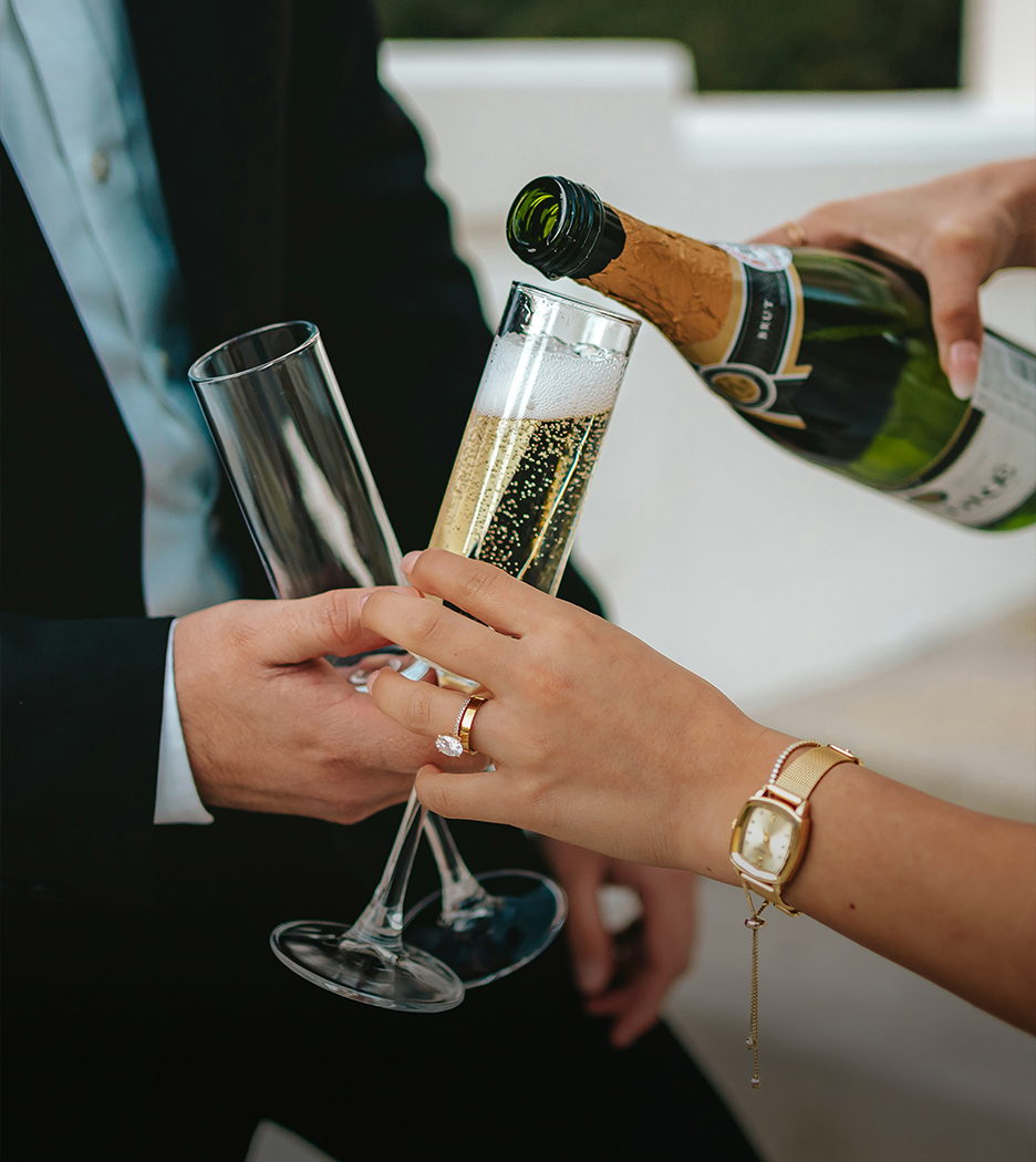 a person pouring champagne into a glass