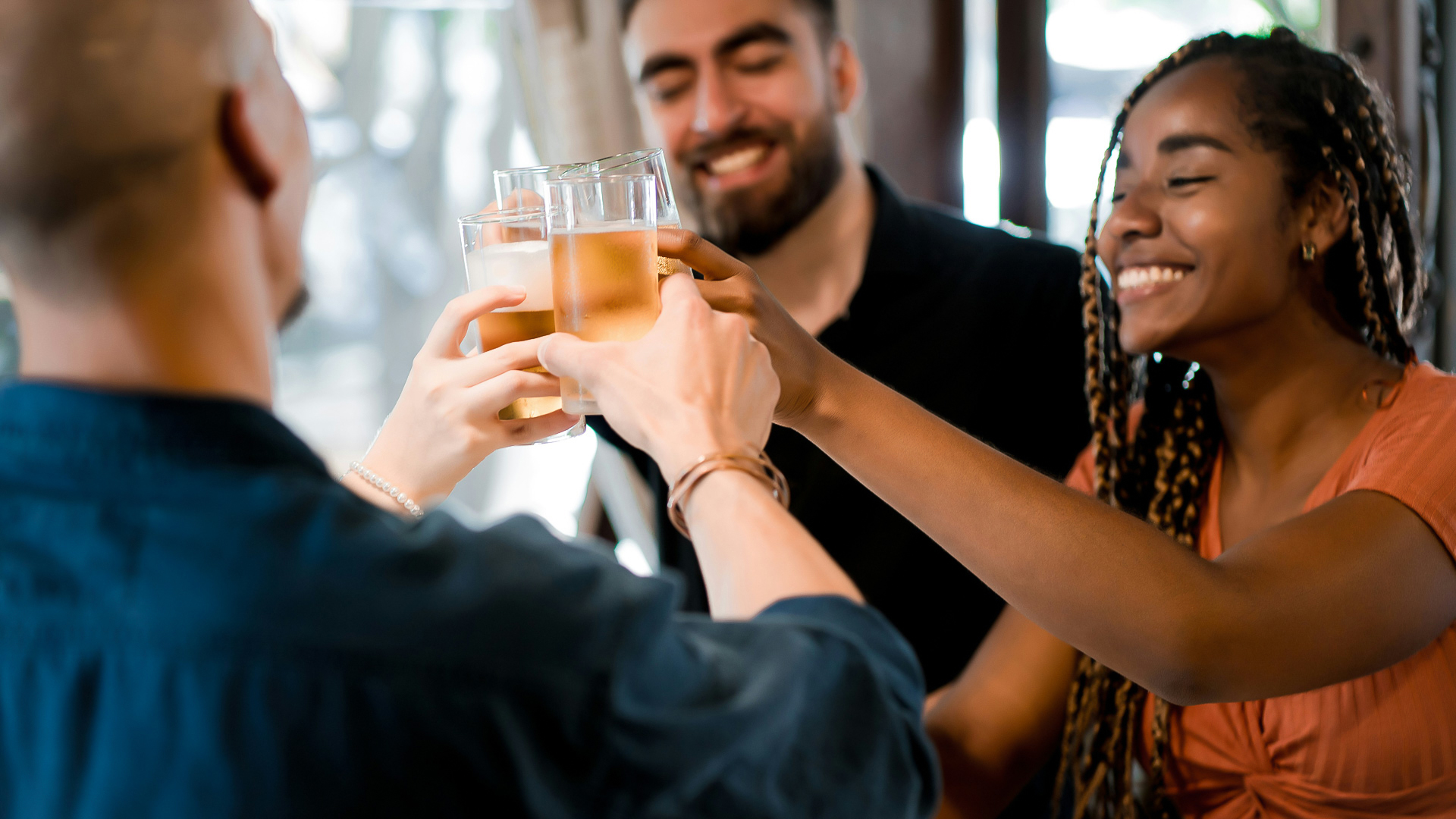 a group of people clinking glasses