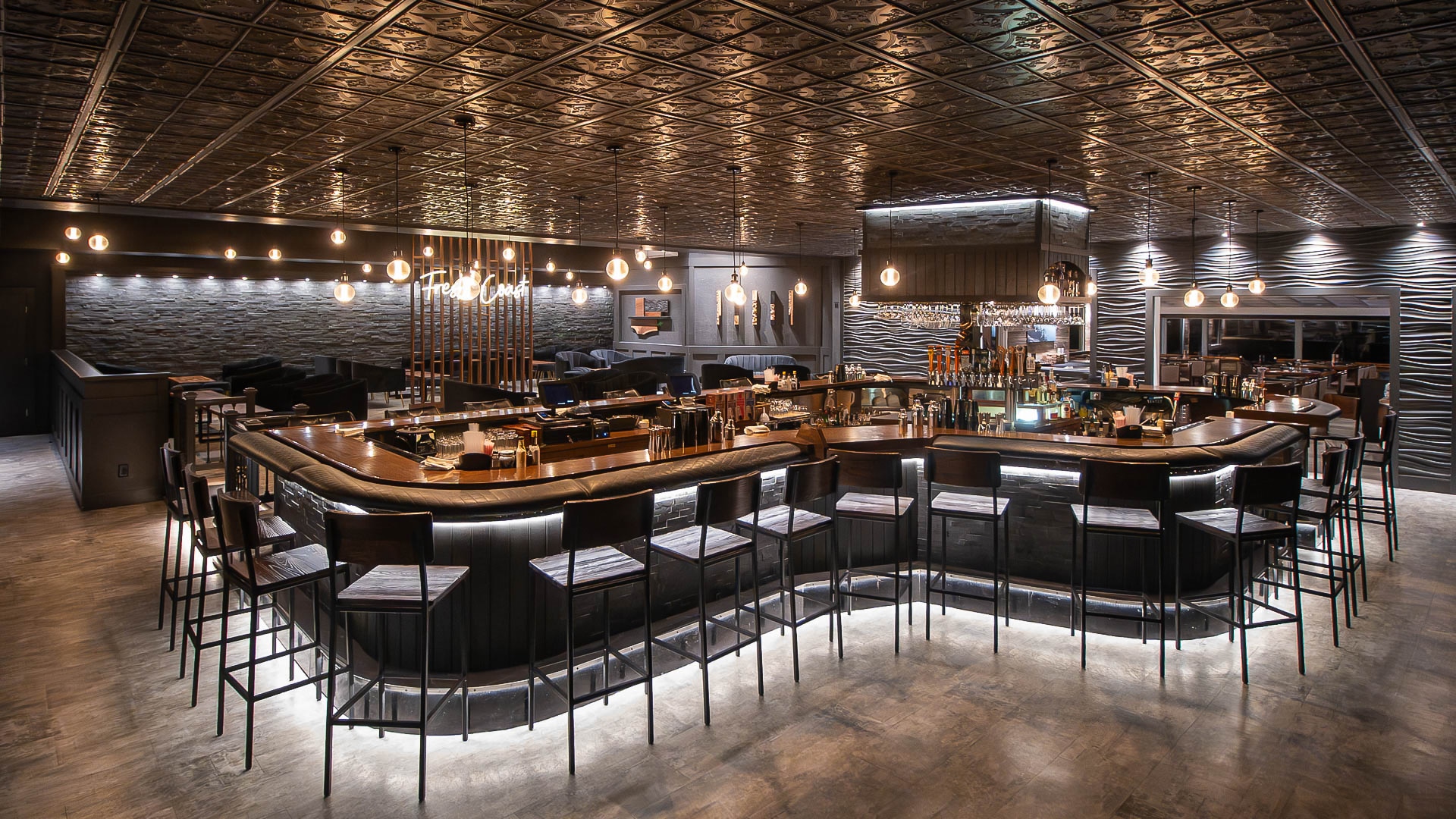 a bar with lights and chairs