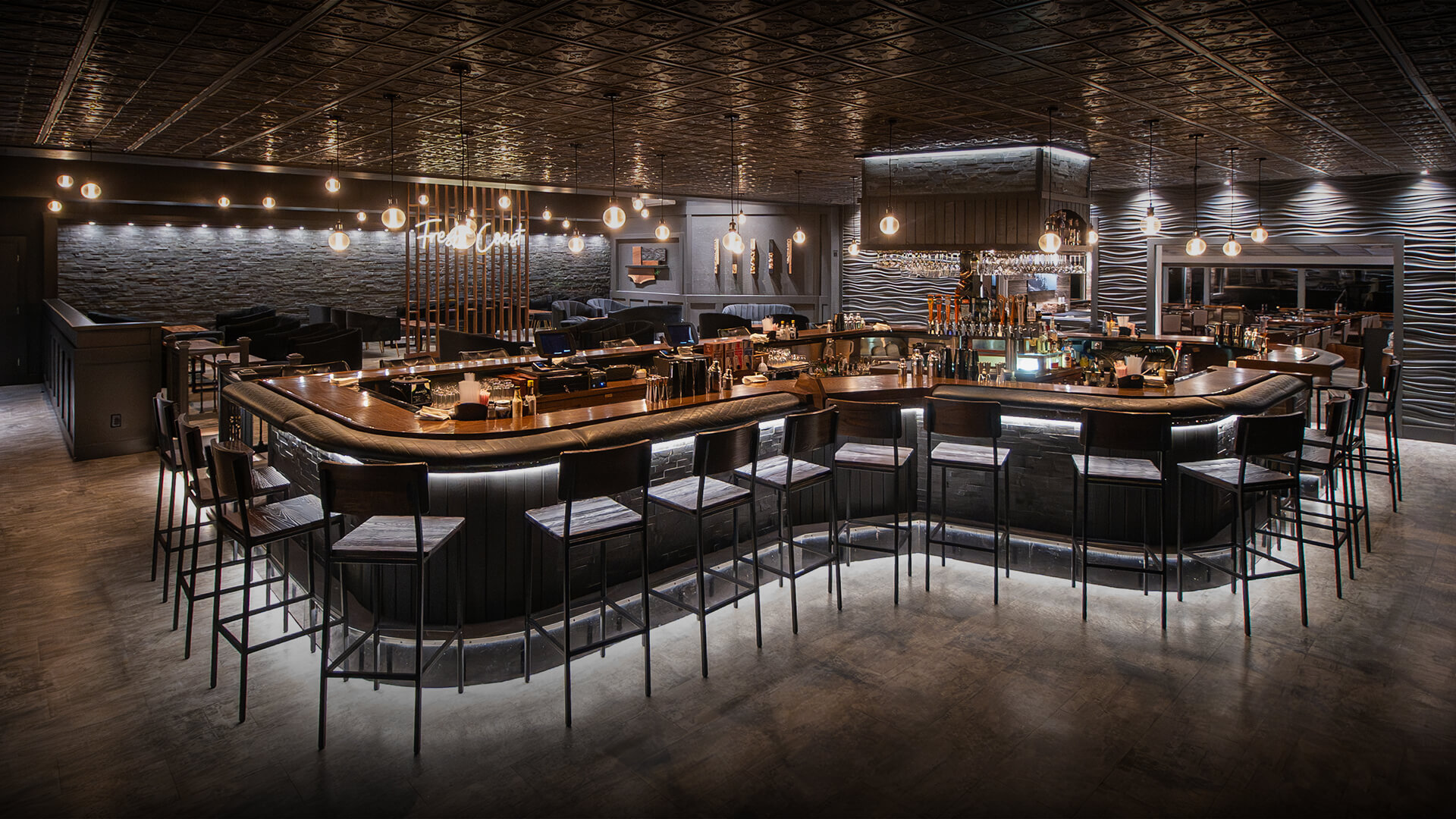 a bar with stools and lights