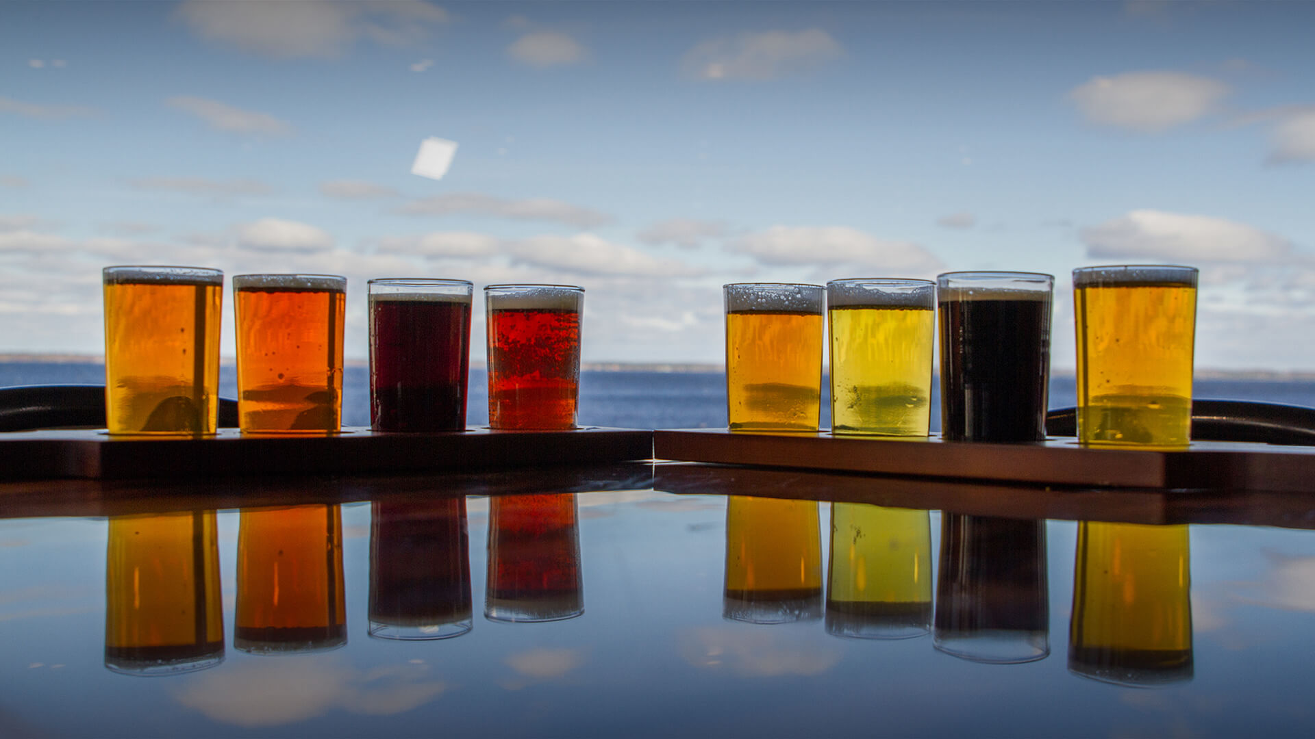 a row of glasses of beer on a table