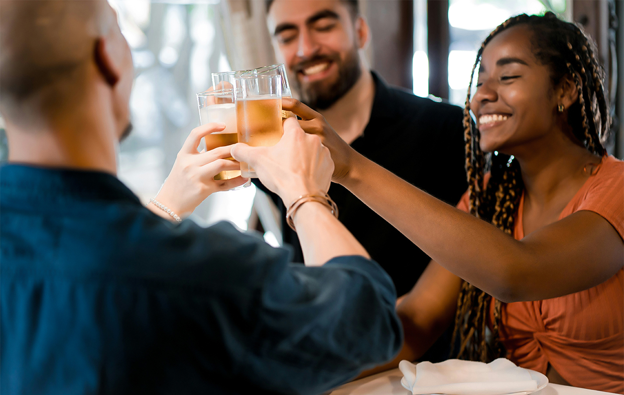 a group of people clinking glasses of beer