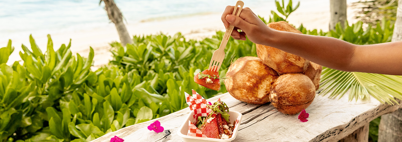 a person holding a fork over a salad