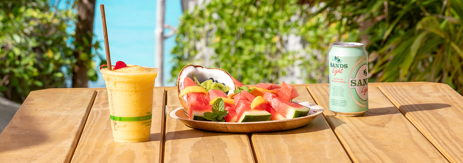 a plate of fruit and a drink on a table