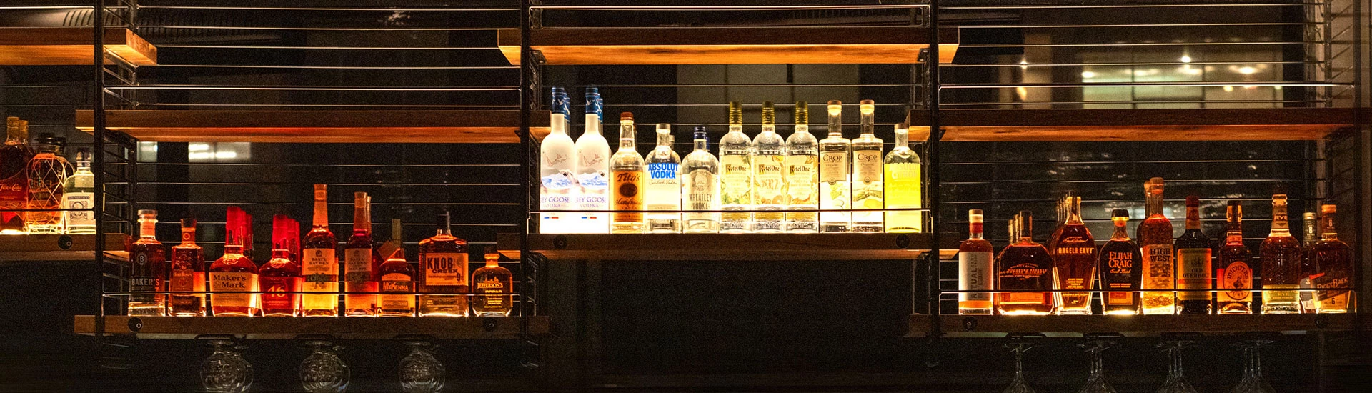 a shelf with bottles of alcohol