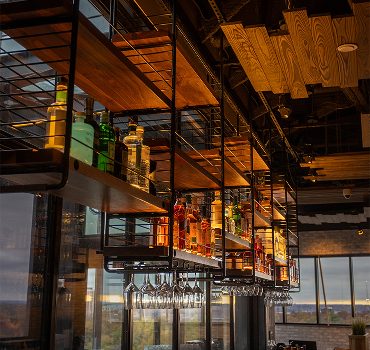 a shelf with bottles and glasses on it