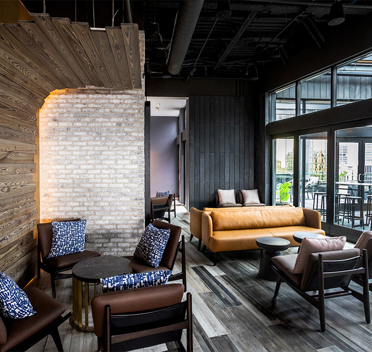 a room with a brick wall and chairs and a table