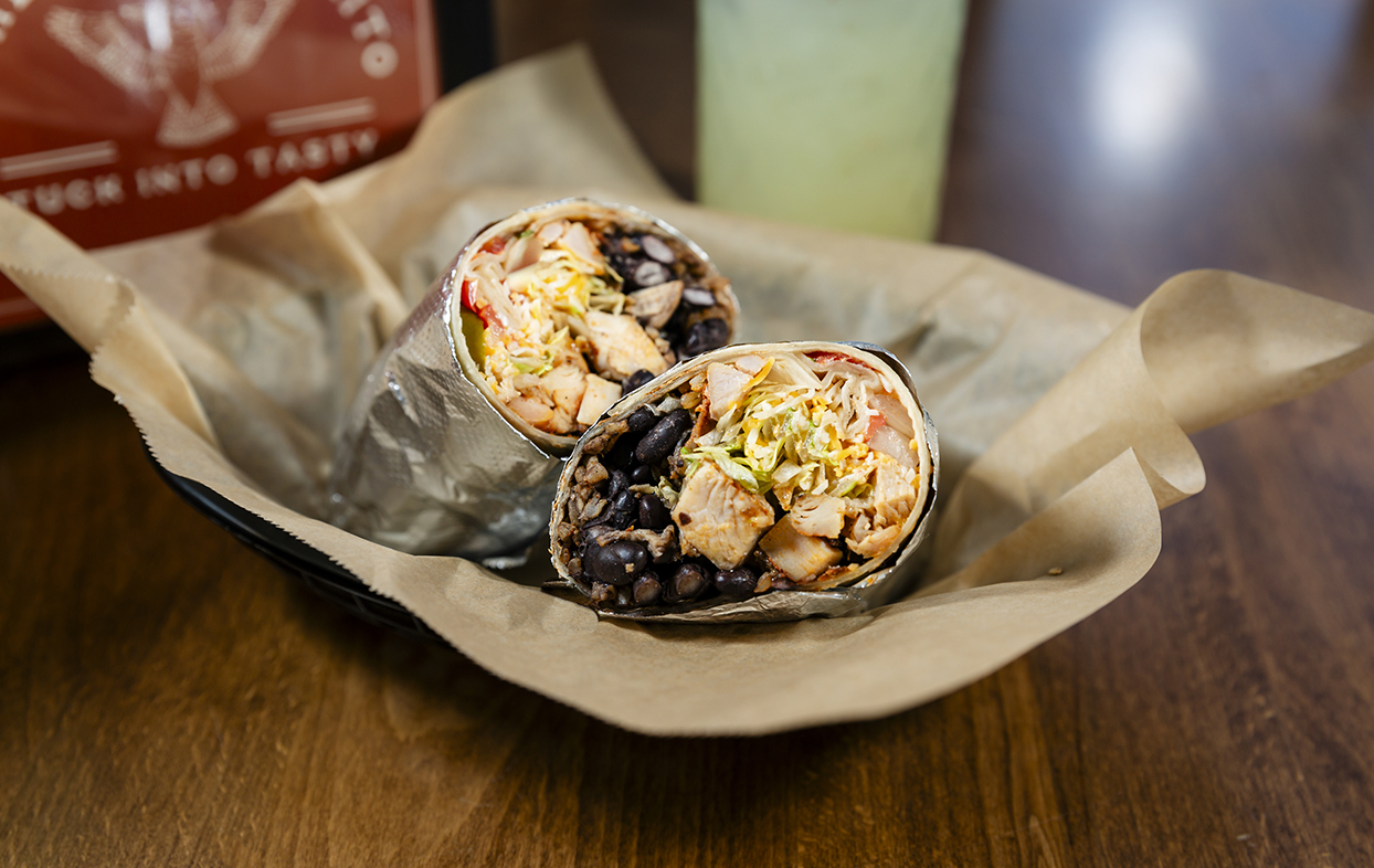 burritos in a basket on a table