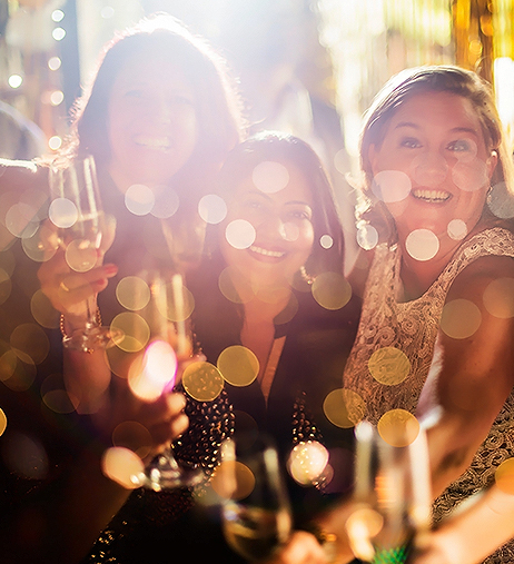 a group of women holding champagne glasses