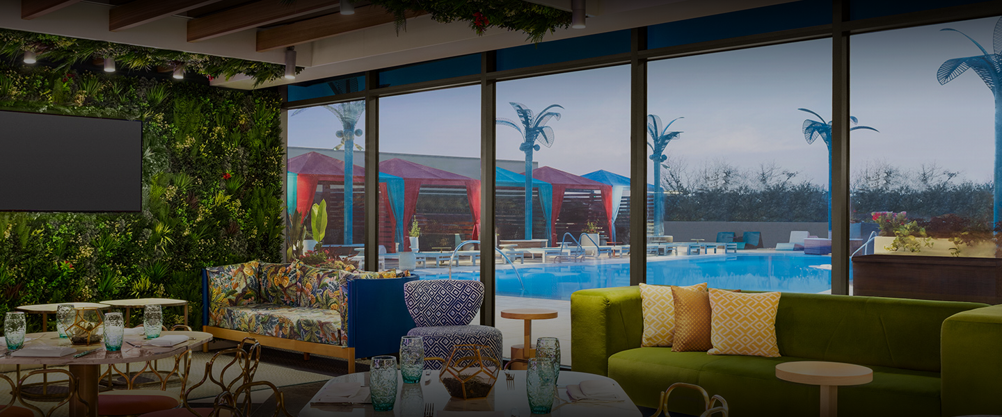 a room with a pool and chairs