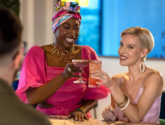 a group of women holding drinks