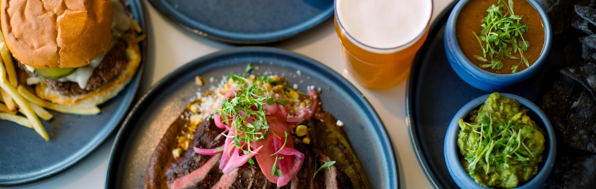 a plate of food and a glass of beer