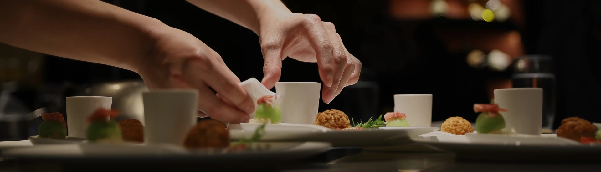 a person's hand over a cup of food