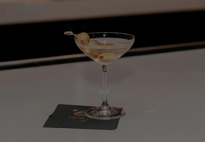 a martini glass with olives on top