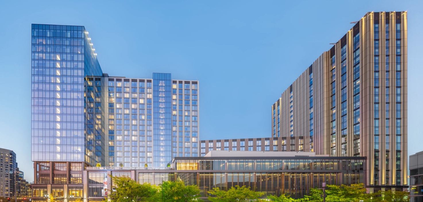 a group of buildings with trees in front of them