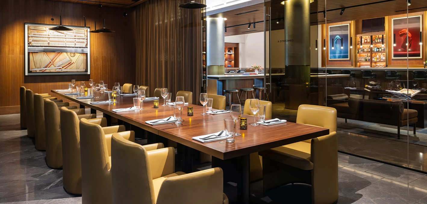 a table with glasses and napkins in a room with a curtain