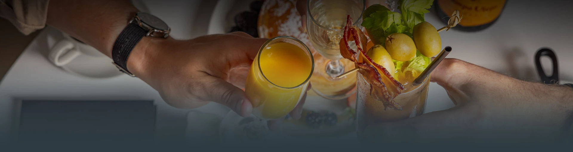 a person holding a glass of orange juice