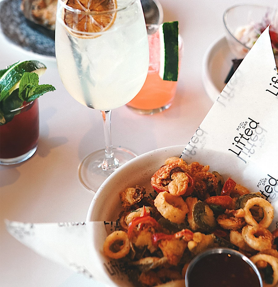 a bowl of food next to a glass of liquid