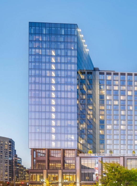 a tall glass building with many windows