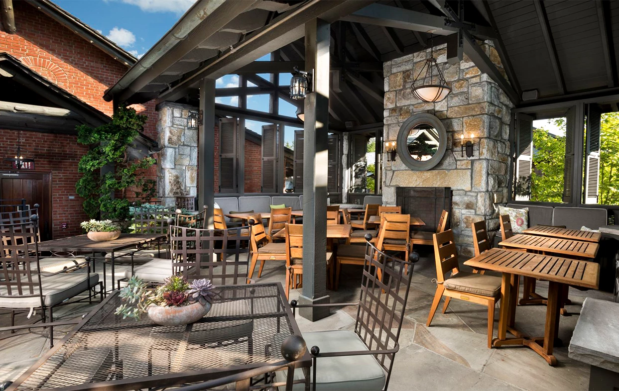 a patio with tables and chairs