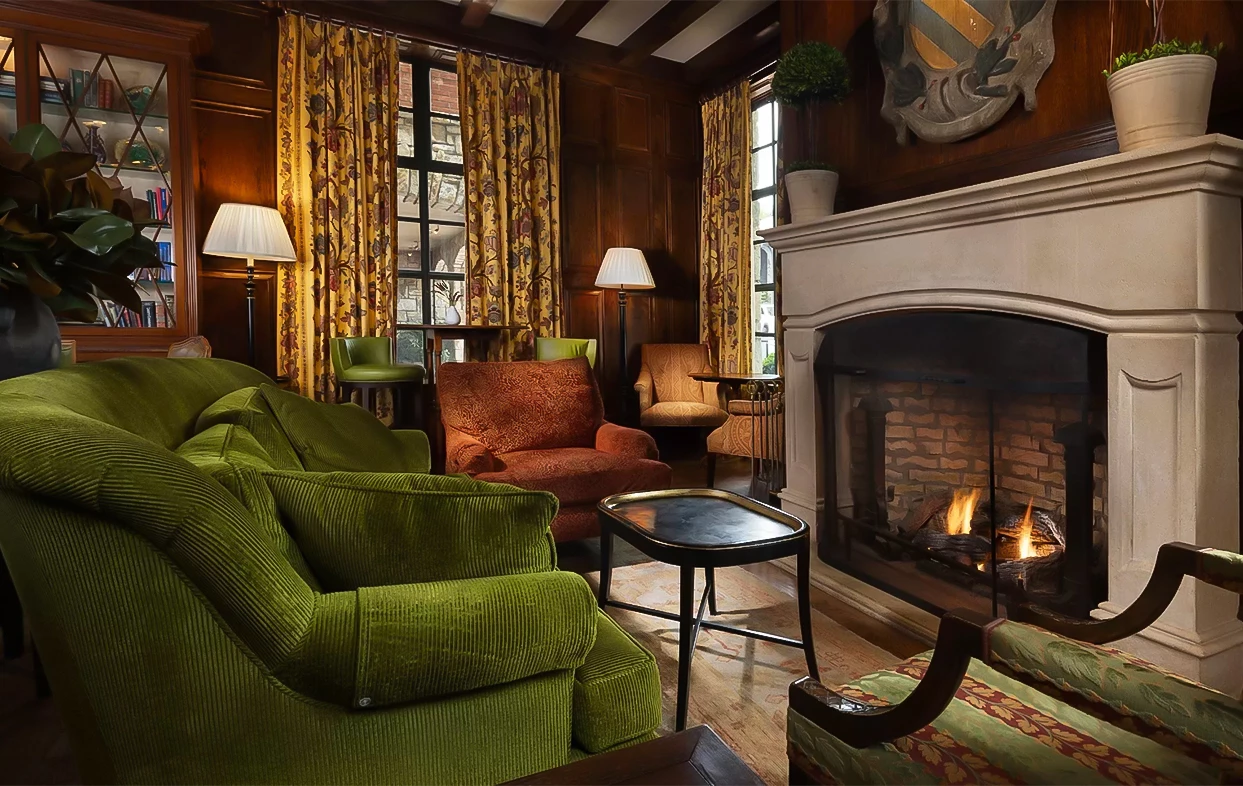 a living room with a fireplace and chairs