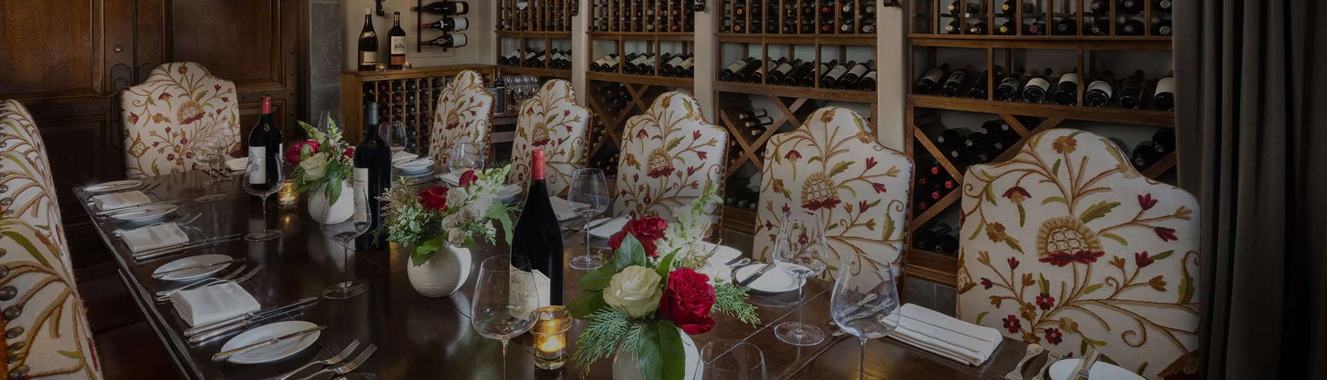a table with wine glasses and wine bottles
