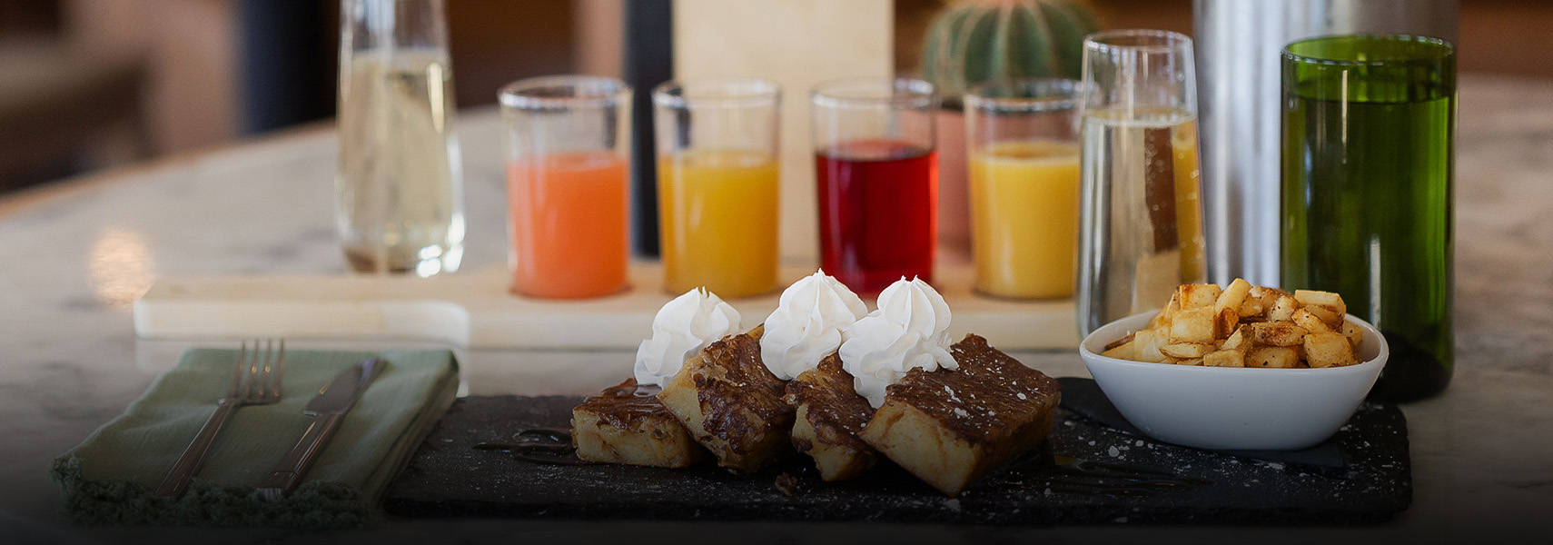a group of glasses with drinks on the table